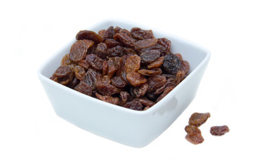 Raisins in square bowl on a white background