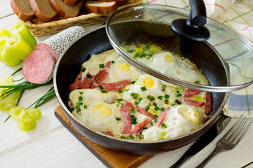 Scrambled eggs fried with sausage slices for delicious breakfast