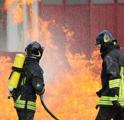 firefighters with oxygen bottles off the fire during a training