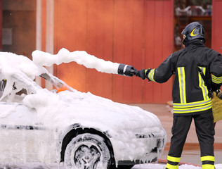 firefighters during exercise to extinguish a fire in a car