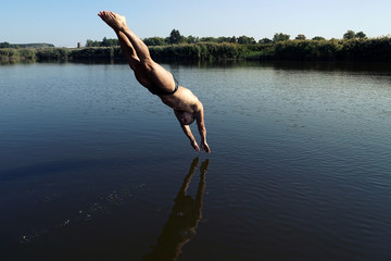 Young man diving into swimming