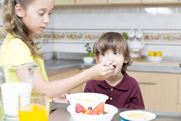 Happy children having breakfast