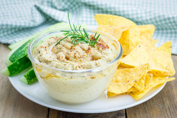 Bowl of classic hummus sprinkled with paprika and sesame