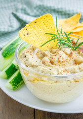 Bowl of classic hummus sprinkled with paprika and sesame