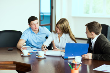 Young business woman with business partners, men at a business m