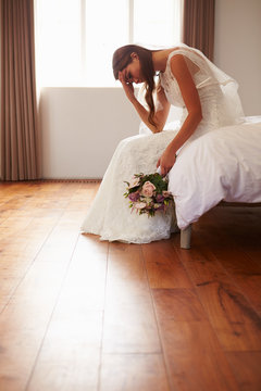 Bride In Bedroom Having Second Thoughts Before Wedding