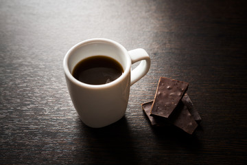 Cup of espresso with dark chocolate