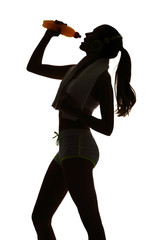 Fototapeta na wymiar one woman exercising fitness drinking energy drink in silhouette