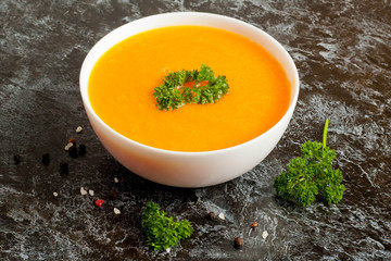 carrot soup with parsley on  table, horizontal