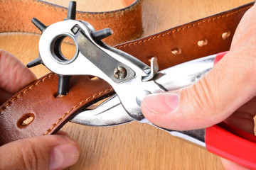 Punching holes on leather belt