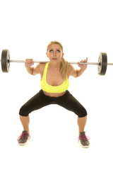 Fototapeta na wymiar woman green sports bra squat weights look up