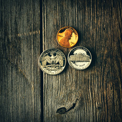 US cent coins over wooden background