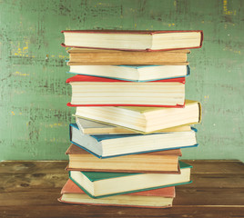 Stack of books on wooden background
