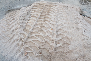 Spuren von Reifen im Sand einer Baustelle