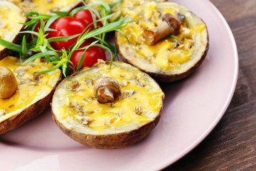 Baked potatoes with cheese and mushrooms on table close up