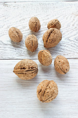 Walnuts on white wooden background