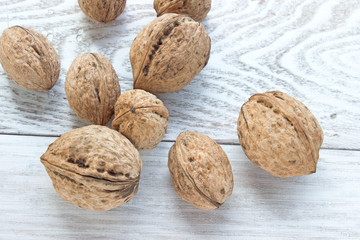 Walnuts on white wooden background