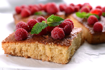 Fresh pie with raspberry on parchment on wooden table, closeup
