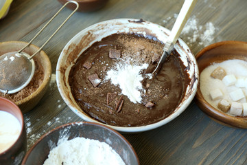 Preparing dough for chocolate pie on table close up