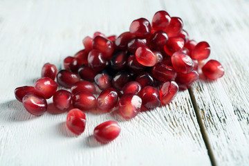 Fresh ripe garnet on wooden table close up