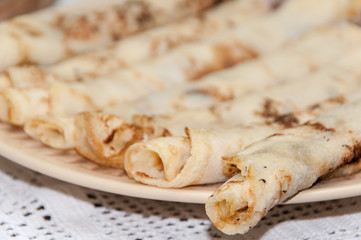 Rolled fresh pancakes on the plate