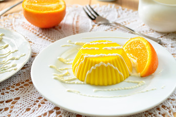 custard pudding with vanilla sauce and orange