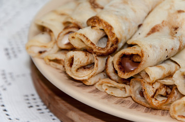 Pancakes stuffed with chocolate cream and served on the plate