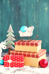 Christmas gifts on color wooden background