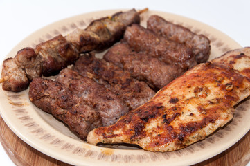 Kebabs and chicken breast on the grill