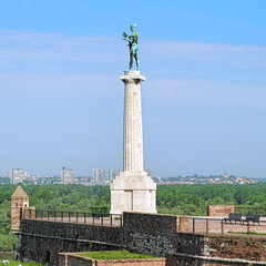 Fototapeta premium Belgrade, Serbia. The Pobednik (The Victor) monument in the Kalemegdan fortress and view of the municipalities New Belgrade and Zemun