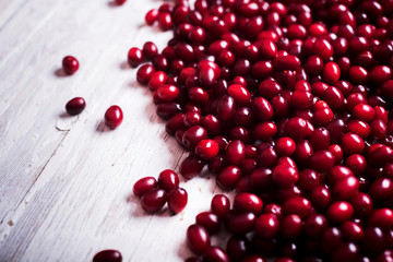  fresh cornel berries on wooden table