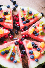 colorful tropical fruit watermelon pizza topped with kiwifruit,