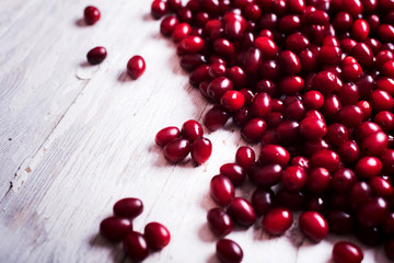  fresh cornel berries on wooden table