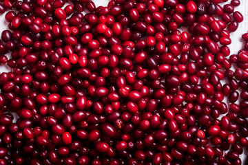  fresh cornel berries on wooden table