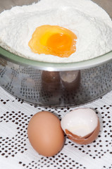 Yolk in the bowl with flour