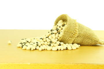 Black eye peas beans in jute bag in white background