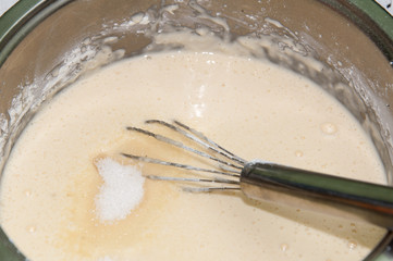 Mixing flour egg and milk for pancakes