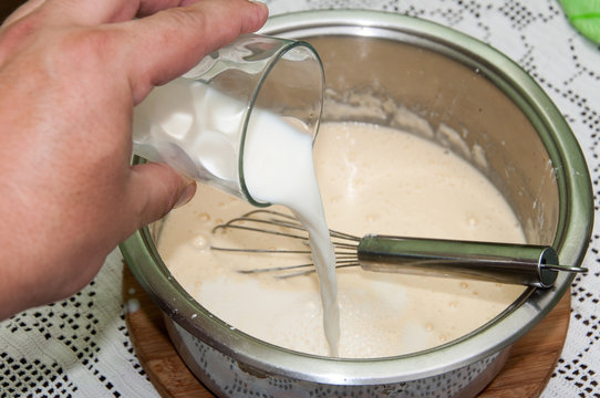 Mixing flour egg and milk for pancakes