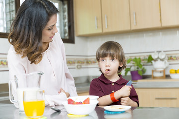 Happy Mother and her boy having breakfast