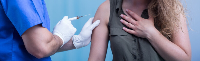 Doctor holding syringe
