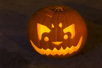 Carved lit Halloween jack o'lantern pumpkin