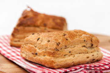 Puff pastry on the kitchen tablecloth and wooden board