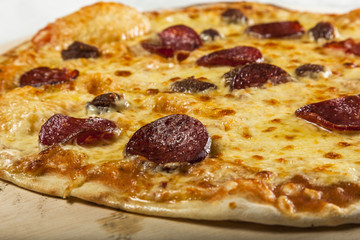 Pizza with salami and pineapple
