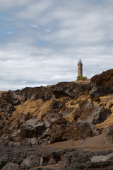 Fototapeta na wymiar Beacon Capelinhos on the shore island Faial, Azores