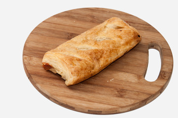 Stuffed pizza puff pastry on the wooden board