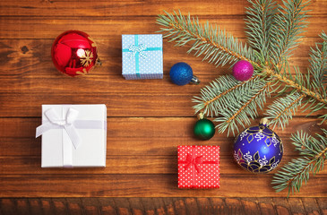Fototapeta na wymiar Christmas gifts, fir-tree branch and christmas toys 