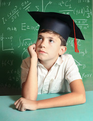  boy in graduation cap   blackboard background