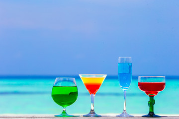 Colorful exotic tasty cocktails in outdoor cafe background
