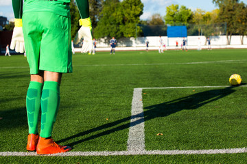 Football goalkeeper in green form and with shadow