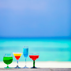 Colorful exotic tasty cocktails in outdoor cafe background